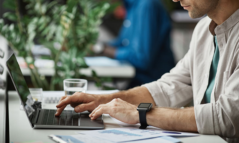 a female typing on a laptop